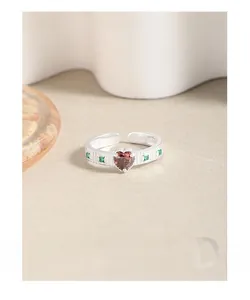 Detail of S925 silver adjustable ring with red heart zircon and green side stones