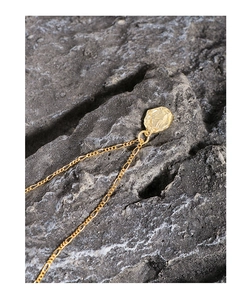 Detail of S925 sterling silver Figaro chain with vintage Roman relief coin pendant