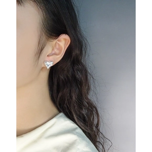Elegant S925 sterling silver heart-shaped stud earrings with faceted crystal on a model
