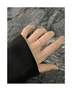 Detailed view of a slender S925 silver ring set with vibrant rainbow cubic zirconia stones