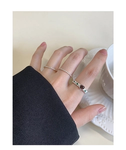 Detailed view of S925 silver ring set featuring a red heart stone and twisted bands
