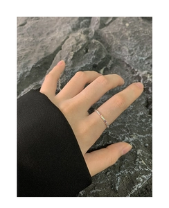 Detail of S925 silver ring with rainbow cubic zirconia on a minimalist thin band