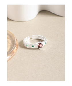 Detailed close-up of S925 sterling silver ring with heart ruby and green zircon stones