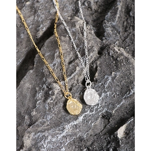 Irregular S925 sterling silver necklace with retro portrait coin pendant on rock surface