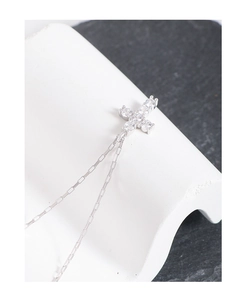 Close-up of S925 sterling silver cross pendant necklace with sparkling zircon stones