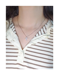 Model wearing a delicate S925 sterling silver cross necklace with sparkling cubic zirconia
