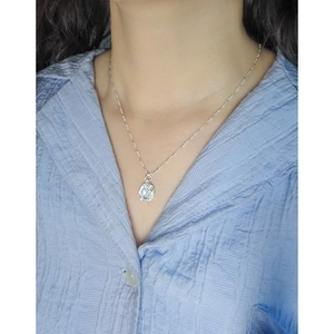 S925 sterling silver necklace with textured irregular oval pendant worn on neck