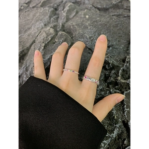 S925 silver rings set with colorful zircons and hammered texture on rocky background