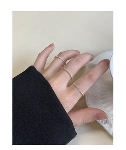 Close-up of minimalist S925 sterling silver beaded rings set on person's hand