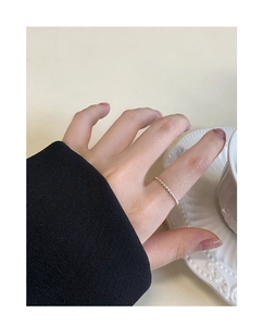 Close-up of minimalist S925 sterling silver beaded ring worn on female finger
