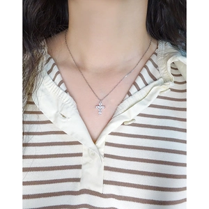 Minimalist S925 sterling silver cross pendant necklace with zircon on a female model