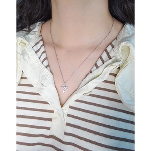 S925 sterling silver cross necklace with clear zircons worn on a female model