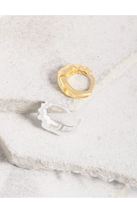 Detailed view of S925 sterling silver hoop earrings with textured scallop design in gold and silver