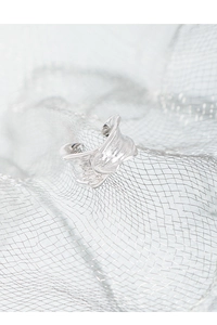 Macro shot of irregular liquid metal texture on S925 silver ear cuff with industrial feel
