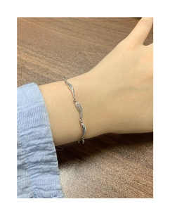 Close-up of S925 sterling silver wave-link bracelet worn on a female wrist