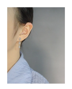 Detail of S925 sterling silver long tassel earrings with minimalist geometric rhombus shapes