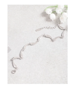 Macro detail of S925 sterling silver ocean wave link bracelet with lobster clasp