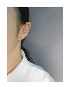 Detailed view of S925 sterling silver croissant earrings with micro-pave crystals on ear