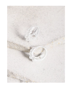 Macro detail of S925 sterling silver stamp and twisted texture on silver hoop earrings