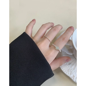 Minimalist S925 silver beaded ring set with light green gemstone on female hand