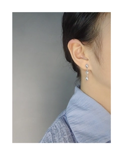 Close-up of elegant S925 silver long drop earrings with geometric rhombus fringe design