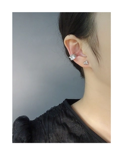 Detail of silver S925 ear cuff set with irregular wavy texture and small bead stud earring