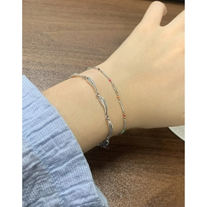 Minimalist S925 sterling silver wave chain bracelets with colorful beads on a female wrist