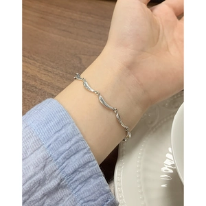 Elegant 925 sterling silver wave link bracelet for women worn on wrist in a lifestyle setting