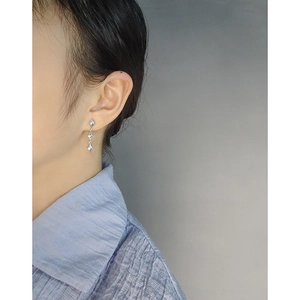 S925 sterling silver long tassel cross star drop earrings worn by a female model