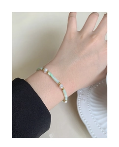 Close-up of S925 silver bracelet featuring baroque pearls and light green shell beads