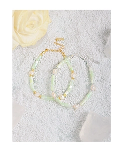 Detail view of S925 sterling silver stamp on baroque pearl and green bead bracelet