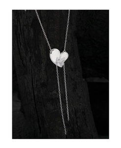 Macro detail of S925 sterling silver heart pendant with shimmering tassel chains