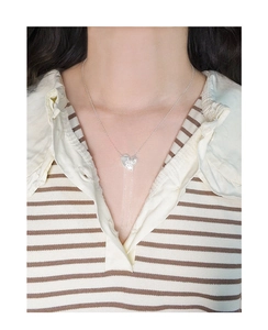 Close-up of S925 sterling silver heart pendant with elegant long tassels on neck