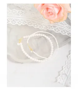 Detail of 925 sterling silver pearl necklace and bracelet set with gold clasps