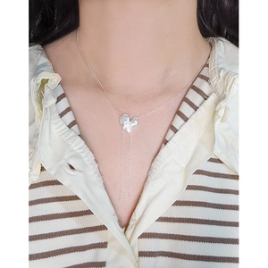 Elegant S925 sterling silver heart necklace with double tassels on a female model