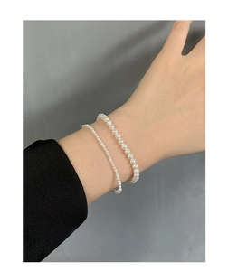 Close-up of S925 sterling silver pearl bracelets with dual sizes on a wrist