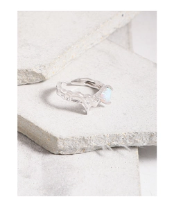 Detail of S925 silver ring featuring organic lava texture and oval opal stone setting