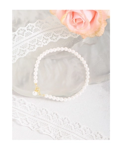 Macro shot of 925 sterling silver pearl bracelet with gold clasp and lace decoration