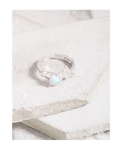 Macro detail of S925 silver ring featuring lava texture and heart-shaped opal stone