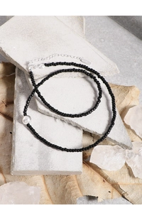 Macro shot of S925 sterling silver lobster clasp and black onyx beads on necklace