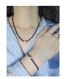 Three-piece black bead jewelry set including necklace, bracelet and ring with silver beads