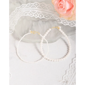 Elegant 14K gold plated S925 silver pearl bracelets with milk white beads and floral background