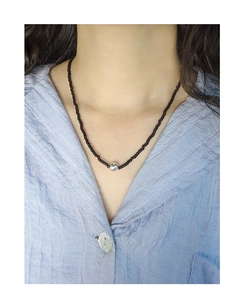 Close-up of S925 sterling silver ball necklace with minimalist black agate beads on neck