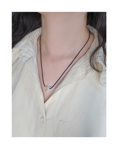 Detail of silver starfish pendant with hammered texture on black cord necklace for women
