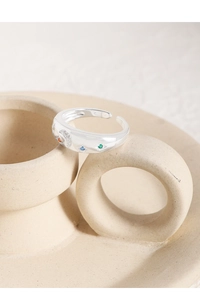 Macro shot of silver crescent moon ring with vibrant multi-color zircon stones