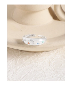 Macro detail of S925 silver ring featuring moon and colorful zircon star patterns