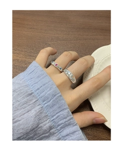 Detailed macro of S925 silver star and moon rings with colorful gemstones on a hand