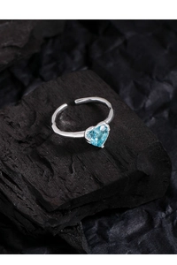 Close-up of a heart-shaped sea blue gemstone set on a minimalist S925 silver ring band