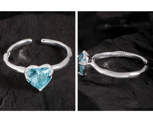 Close-up of S925 sterling silver stamp and heart-shaped light blue gemstone on ring
