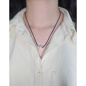 Minimalist S925 sterling silver starfish pendant with black cord on model neck